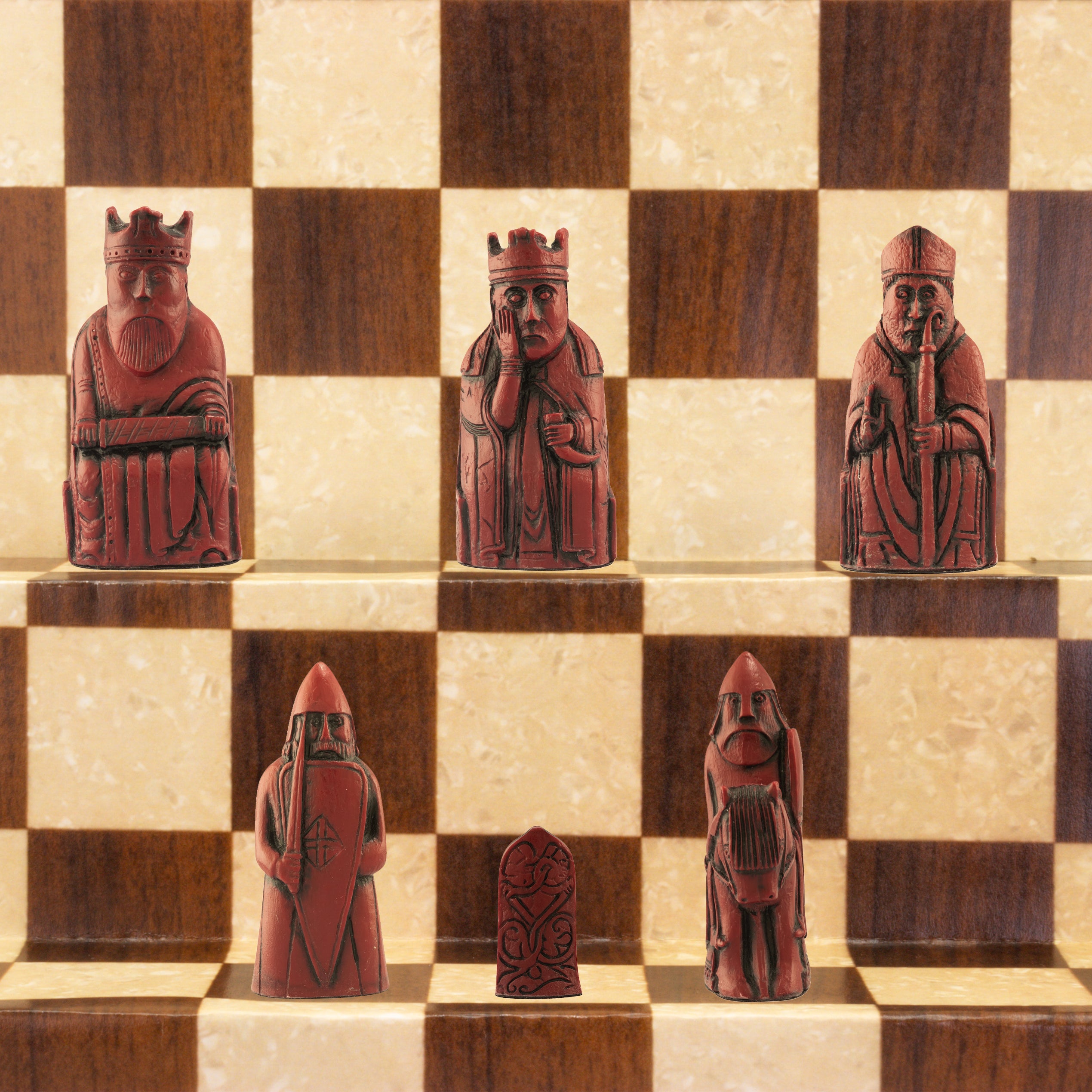 A handmade recreation of The Isle of Lewis Chess Set, the oldest known chess set.
In 1831 the sea carried away a sandbank on the Isle of Lewis uncovering a mysterious building that had been buried under the sand. A peasant working nearby found what he concluded to be a collection of Elves and Gnomes. The superstitious highlander flung down his spade and fled home in horror.