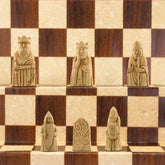 A miniature chess set inspired by the Isle of Lewis chessmen, the oldest known chess set.
In 1831 the sea carried away a sandbank on the Isle of Lewis uncovering a mysterious building that had been buried under the sand. A peasant working nearby found what he concluded to be a collection of Elves and Gnomes. The superstitious highlander flung down his spade and fled home in horror.