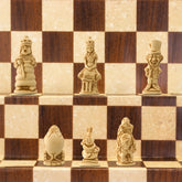 A handmade chess set featuring characters from Alice in Wonderland, placed on a checkered background.