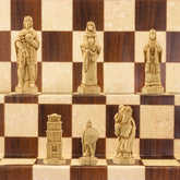 A handmade chess set depicting characters from the Battle of Hastings, with pieces representing King Harold II of England, Edith Swan-Neck, Archbishop Stigand, William the Conqueror, and other Saxon and Norman figures, placed on a checkered background.