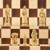 One side of a hand made themed chess set, inspired by the legend surrounding Robin Hood. This side contains Robin Hood as the King, Maid Marian as the Queen, Friar Tuck as the Bishop, Will Scarlet as the Knight, A Sherwood Tree as the Rook & The Merry Men as the Pawn pieces.
These pieces are coloured in a ivory style.