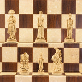A hand made chess set depicting characters from the Battle of Waterloo, placed on a checkered board.