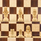 The ivory coloured side of a hand made themed chess set, designed with a blend of the classic styles of Staunton and the Old French Dieppe, featuring characters such as Richard I as the King, Elanor of Aquitaine as the Queen, Hubert Walder as the Bishop, A Lion as the Knight, and William Marshall as the Pawn.