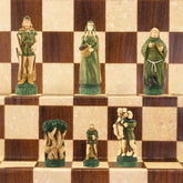 One side of a hand painted themed chess set, inspired by the legend surrounding Robin Hood. This side contains Robin Hood as the King, Maid Marian as the Queen, Friar Tuck as the Bishop, Will Scarlet as the Knight, A Sherwood Tree as the Rook & The Merry Men as the Pawn pieces.