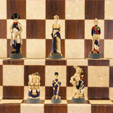 Hand-painted chess pieces depicting characters from the Battle of Waterloo, placed on a chessboard.
