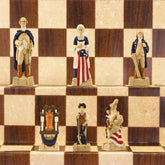 Hand-painted chess pieces depicting figures from the American Revolutionary War, placed on a chessboard.