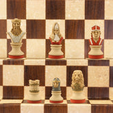 The blue coloured side of a hand painted themed chess set, designed with a blend of the classic styles of Staunton and the Old French Dieppe, featuring characters such as Richard I as the King, Elanor of Aquitaine as the Queen, Hubert Walder as the Bishop, A Lion as the Knight, and William Marshall as the Pawn.