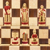 The red coloured side of a handmade and hand painted chess set depicting Shakespeare, Lady Macbeth, Sir John Fallstaff, Nick bottom & The Globe theatre displayed on a wooden chess board.