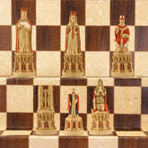 The red coloured side of a hand painted chess set inspired by the architecture and statuary in and around Medieval Cathedrals, a chess set of gracious proportions and great detail.