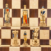 Hand-painted chess pieces depicting characters from the Battle of Bannockburn, placed on a chessboard.