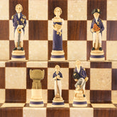 A hand-painted chess set depicting characters related to the Battle of Trafalgar, with a blue and white colour scheme, displayed on a chessboard.