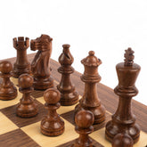 Wooden chess pieces on a chessboard with a white background