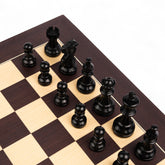 Black chess pieces on a wooden chessboard with checkered pattern