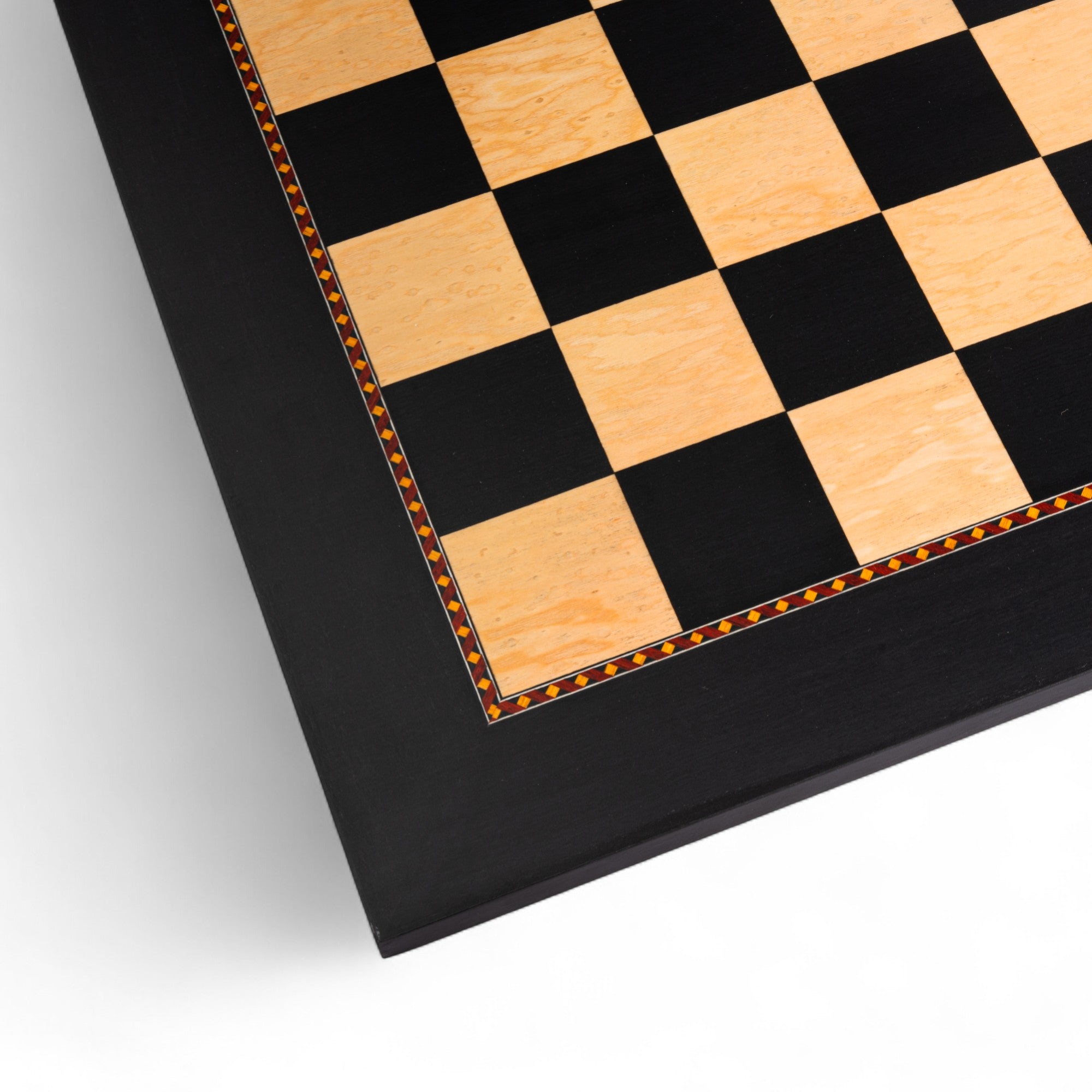 Close-up of a checkered wooden surface with black and light brown squares on a white background