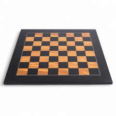 Wooden chessboard with black and brown checkered pattern on a white background