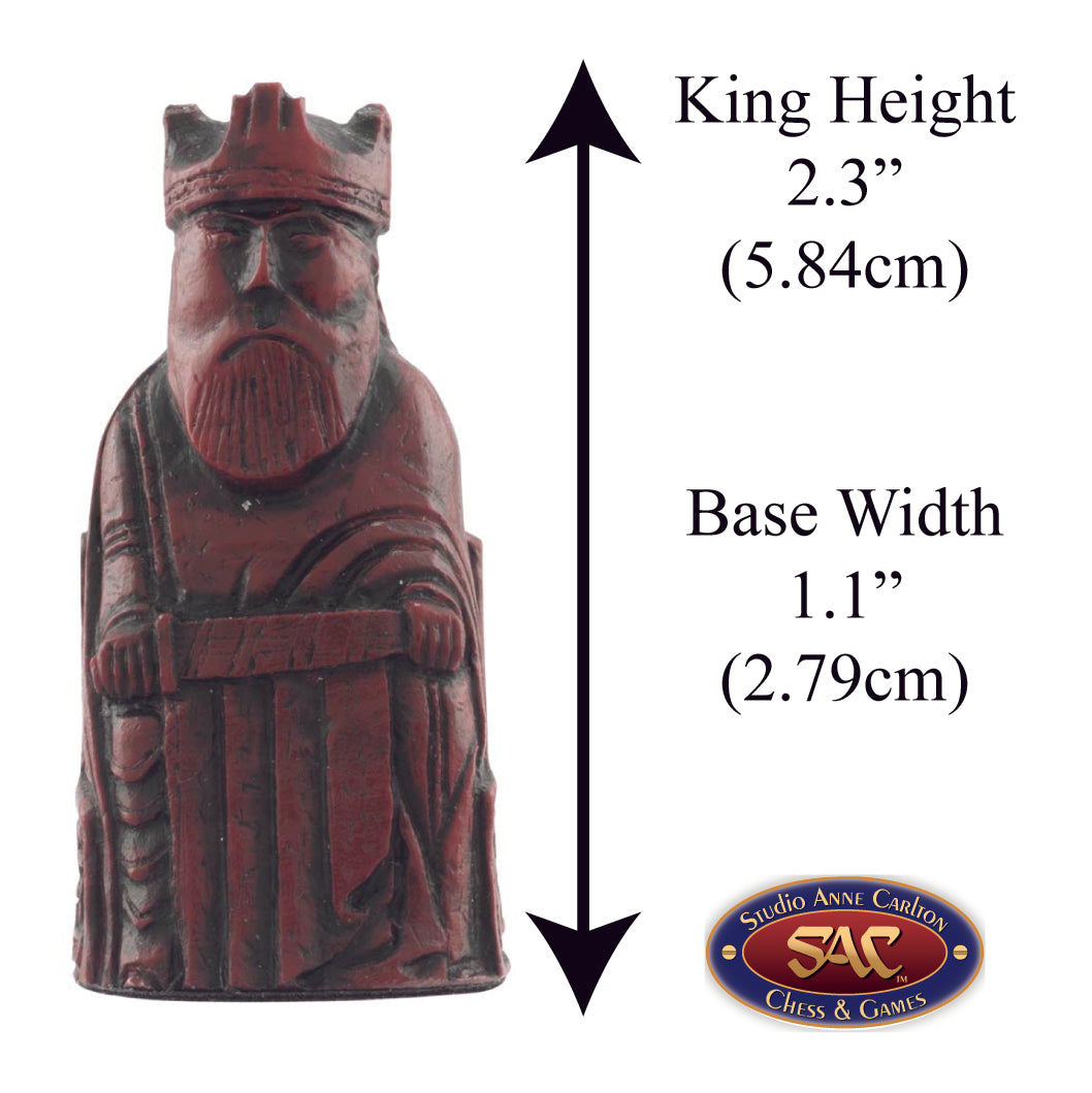 A handmade chess piece from the Isle of Lewis set, Alongside measurement information.

In 1831 the sea carried away a sandbank on the Isle of Lewis uncovering a mysterious building that had been buried under the sand. A peasant working nearby found what he concluded to be a collection of Elves and Gnomes. The superstitious highlander flung down his spade and fled home in horror.
