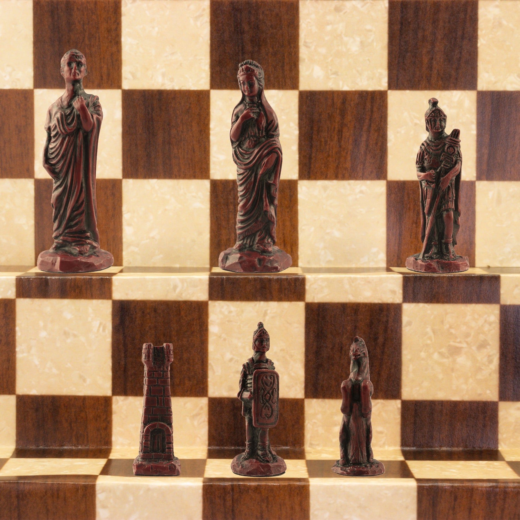 The burgundy coloured side of a handmade chess set depicting Roman era figures, displayed on a wooden chess board.