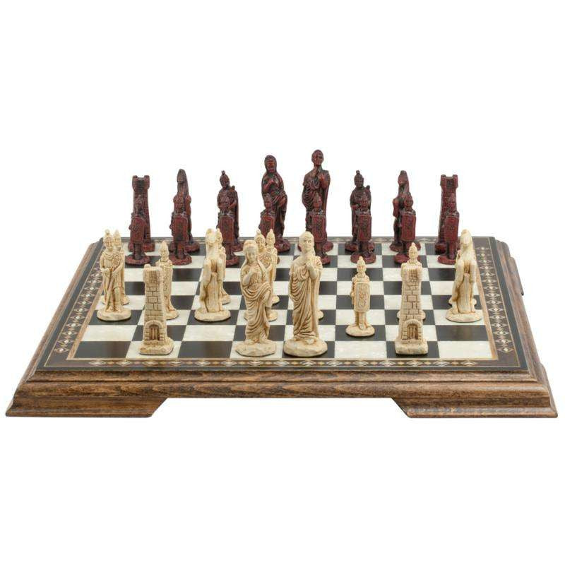 A handmade chess set depicting Roman era figures, displayed on a wooden chess board.