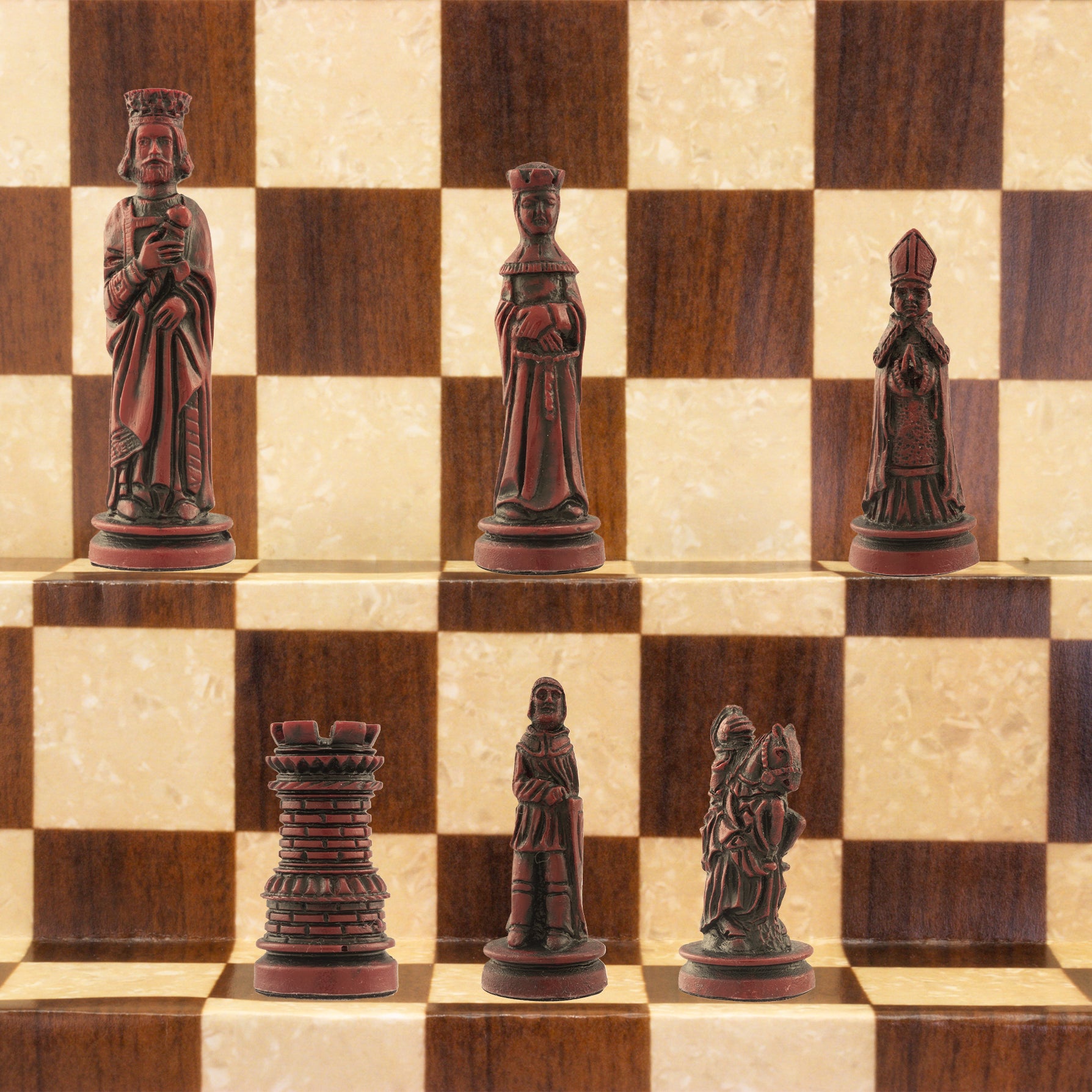 The burgundy coloured side of a handmade miniature chess set with pieces crafted in the design of a typical Western European court in the Middle Ages. The costumes and architecture of the period are faithfully reproduced.