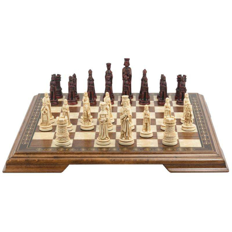 A handmade miniature chess set with pieces crafted in the design of a typical Western European court in the Middle Ages, displayed on a rotating chess board.
