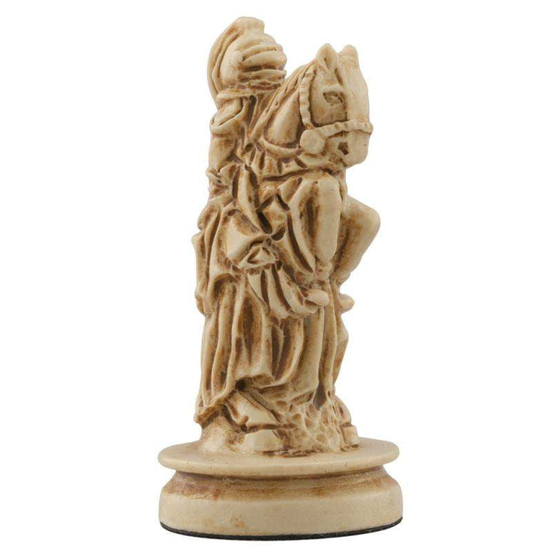A hand made ivory coloured chess piece depicting a Mounted Knight wearing clothing faithful to a typical western european court in the Middle Ages.