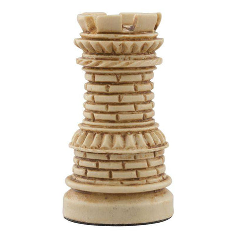 A hand made ivory coloured chess piece depicting a Castle tower, with architecture that was typical in a western european court in the Middle Ages.