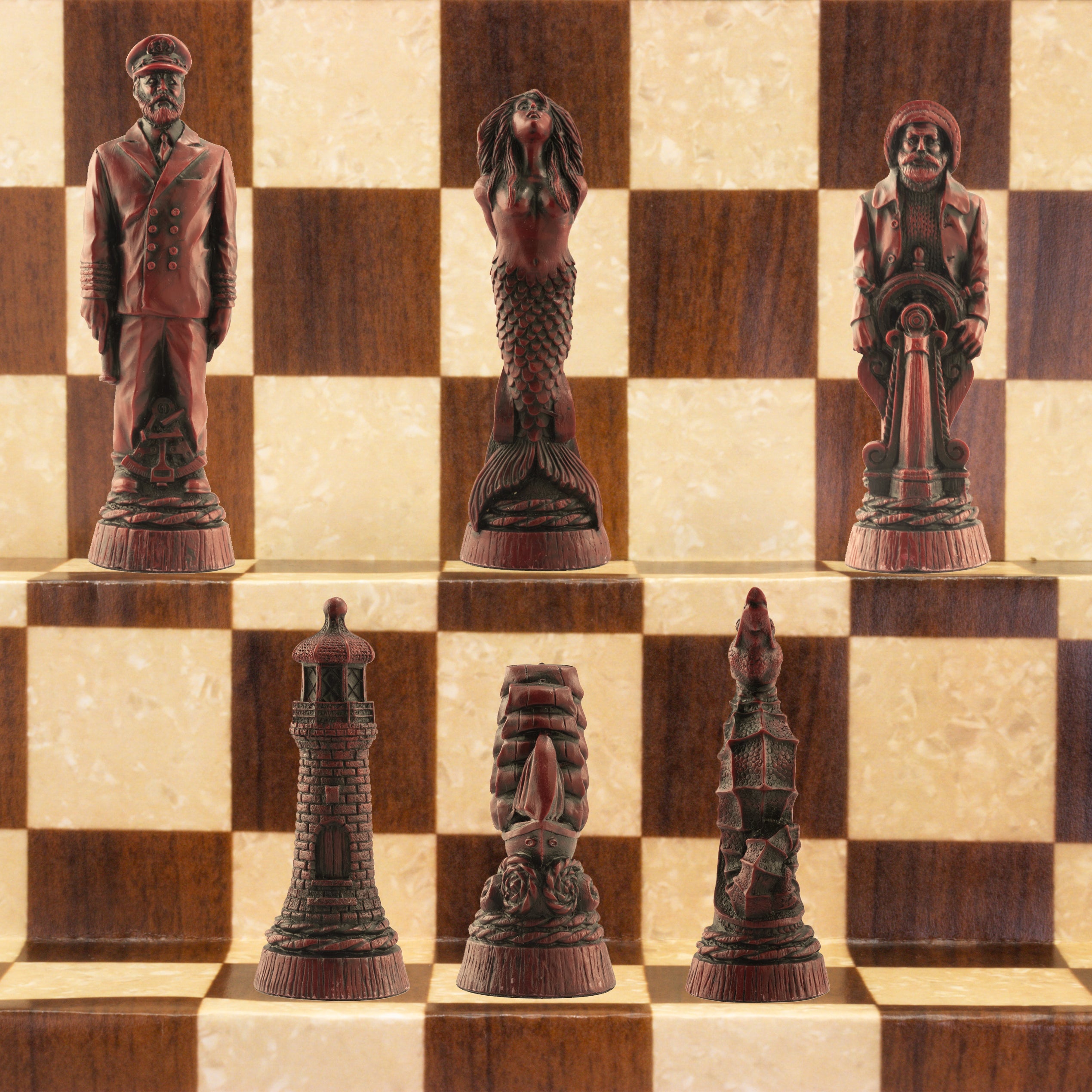 The burgundy coloured side of a nautical-themed chess set with pieces including a Captain, Mermaid, Navigator, Seahorse, Lighthouse, and Ship, displayed on a brown and beige chess board.