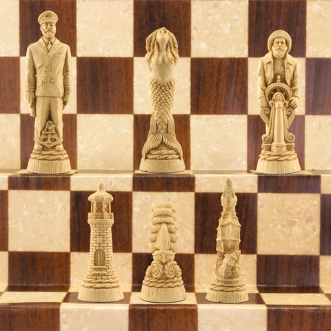 The ivory coloured side of a nautical-themed chess set with pieces including a Captain, Mermaid, Navigator, Seahorse, Lighthouse, and Ship, displayed on a brown and beige chess board.