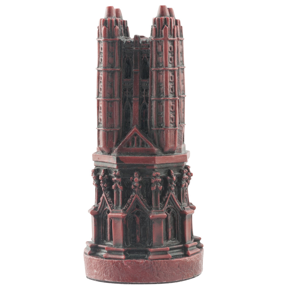 A handmade burgundy coloured chess piece depicting a magnificent bell tower, typically found in most cathedrals.
