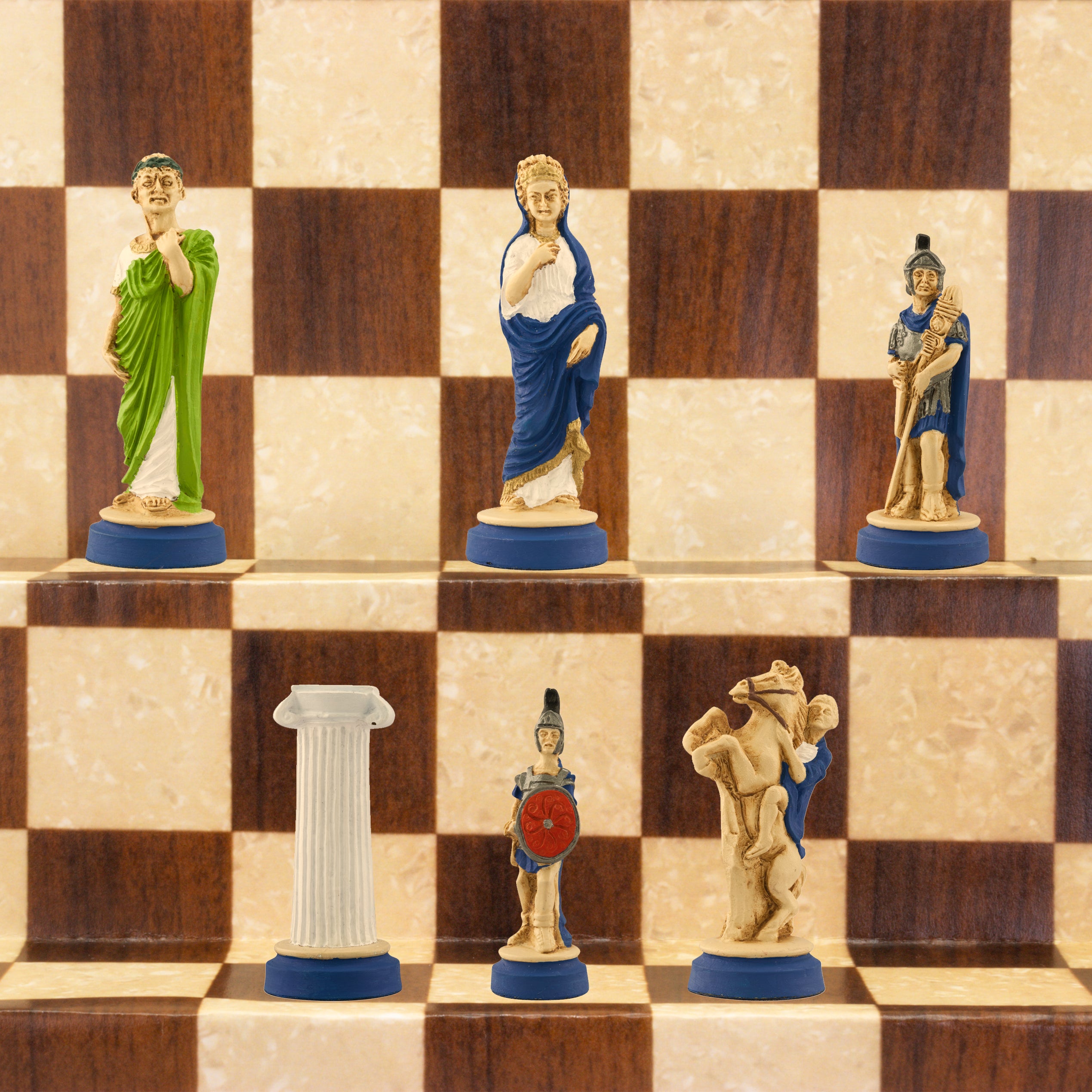 The blue side of a handmade chess set with pieces painted in colours and details depicting Roman era figures, displayed on a wooden chess board.