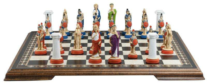 A handmade chess set with pieces painted in colours and details depicting Roman era figures, displayed on a wooden chess board.