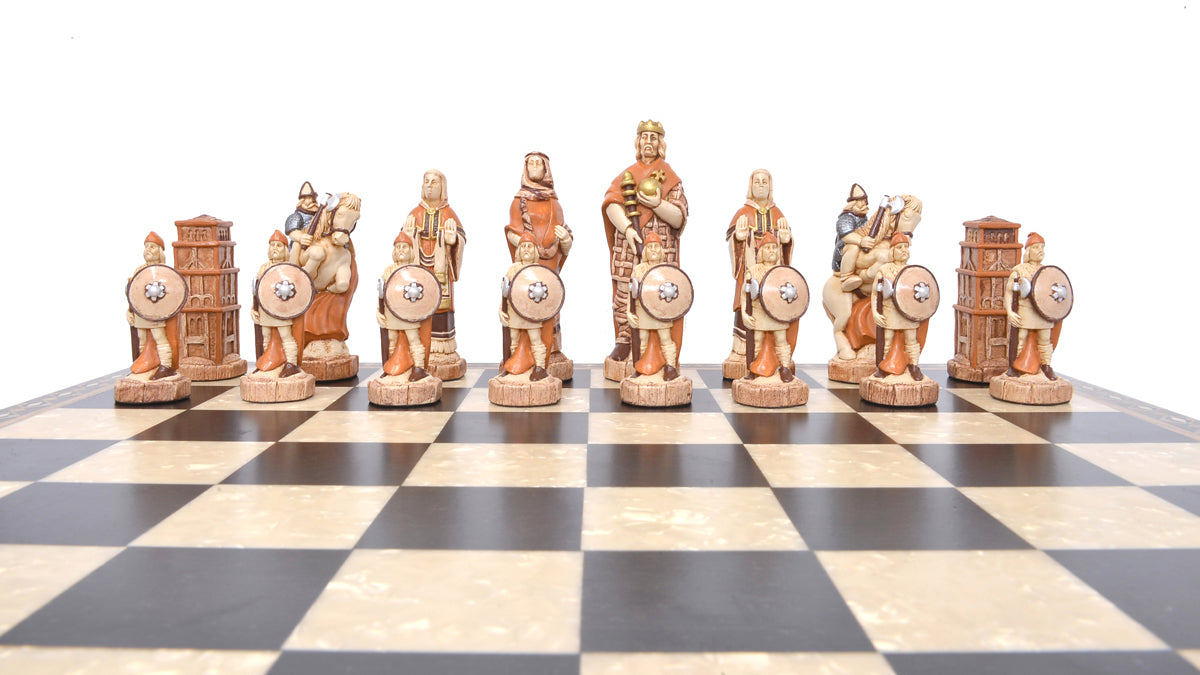 A handmade chess set depicting characters from the Battle of Hastings, with pieces representing King Harold II of England, Edith Swan-Neck, Archbishop Stigand, William the Conqueror, and other Saxon and Norman figures, placed on a checkered background.