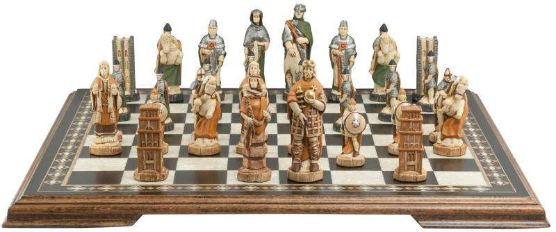 A handmade chess set depicting characters from the Battle of Hastings, with pieces representing King Harold II of England, Edith Swan-Neck, Archbishop Stigand, William the Conqueror, and other Saxon and Norman figures, placed on a chess board.