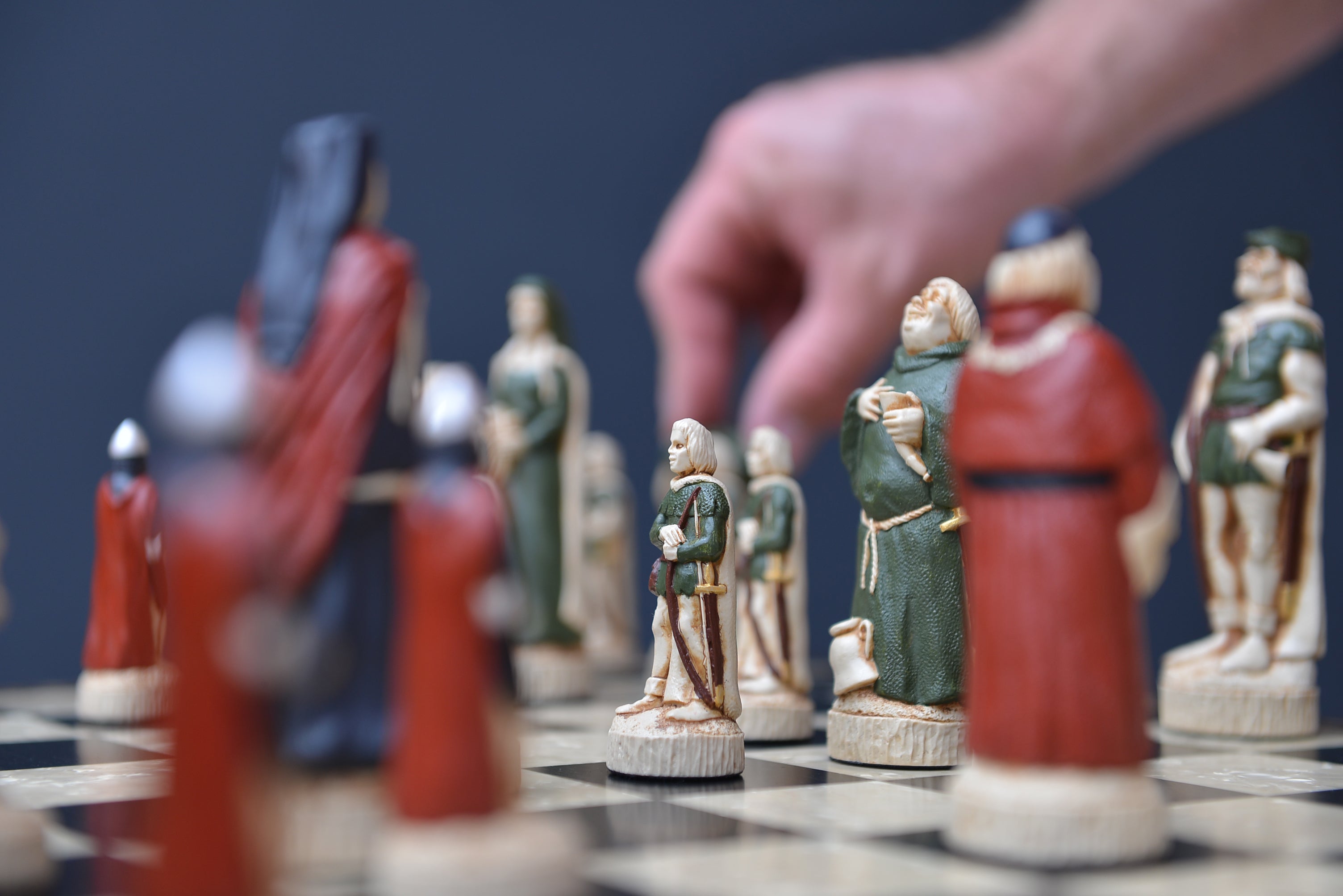 A lifestyle shot showcasing a hand painted themed chess set, inspired by the legend surrounding Robin Hood. 
