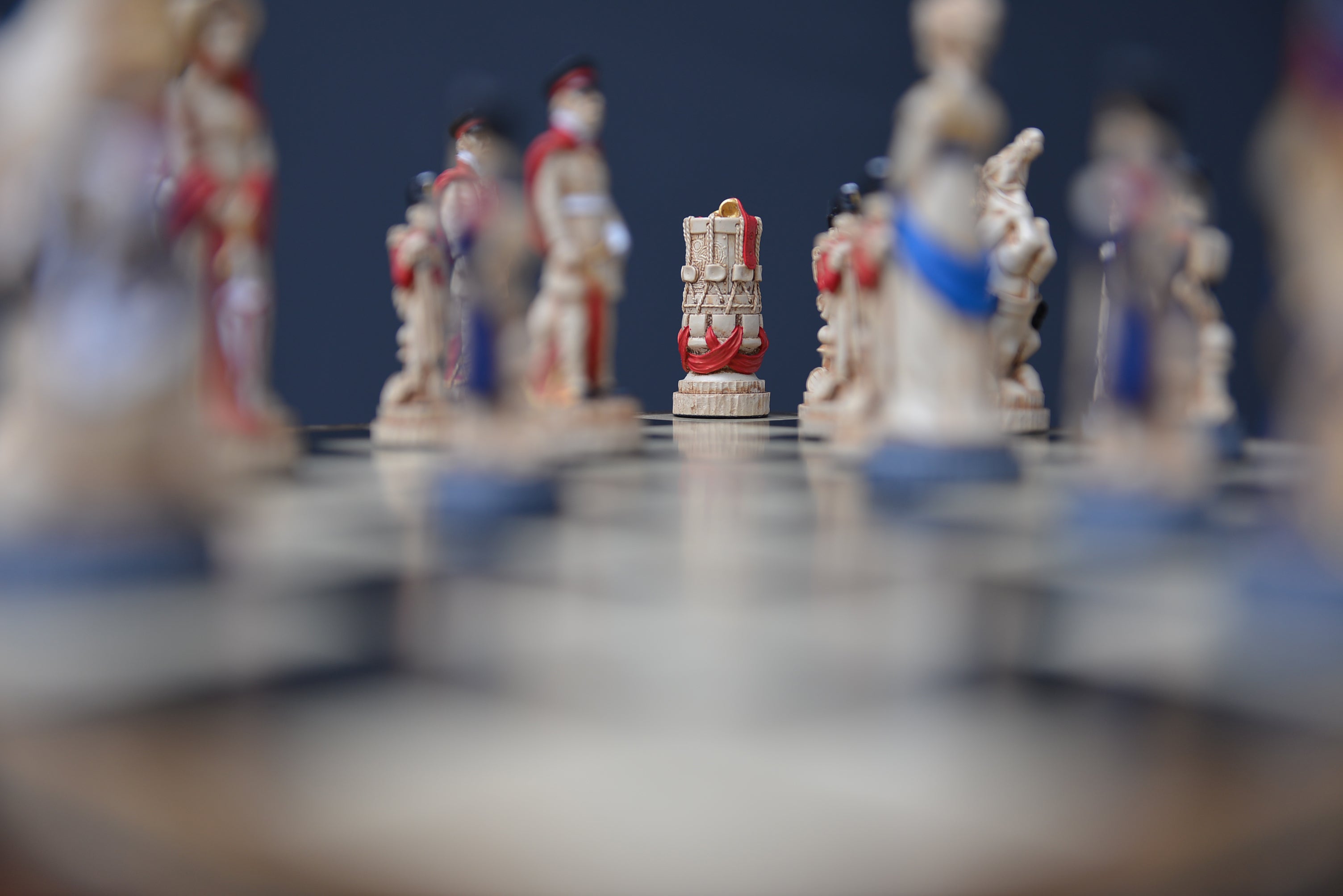 A hand made chess set depicting characters from the Battle of Waterloo, placed on a chess board in a lifestyle shot.