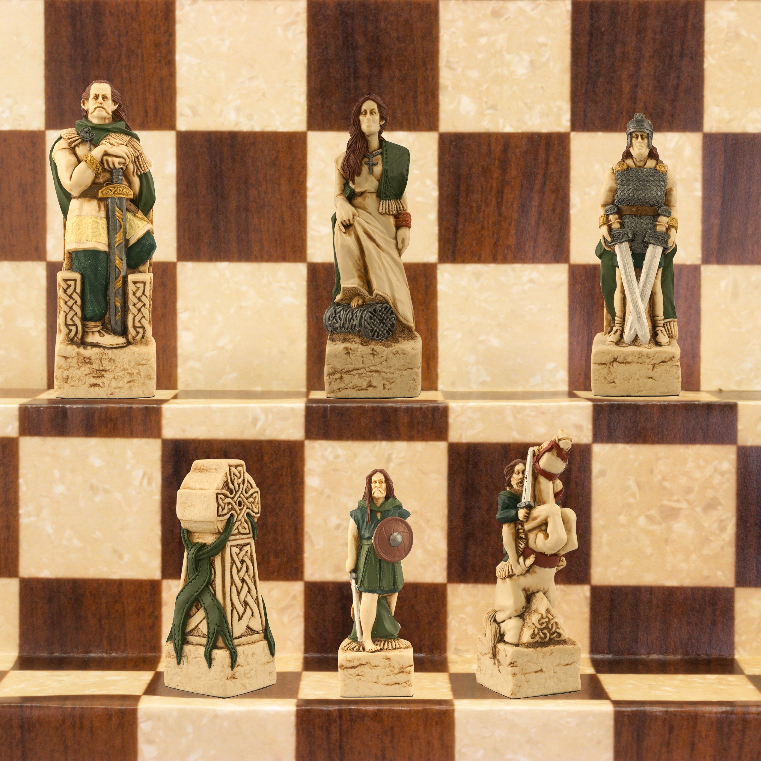 A close-up of a handmade chess set with pieces designed in Celtic and Viking styles, set up on a wooden chess board.