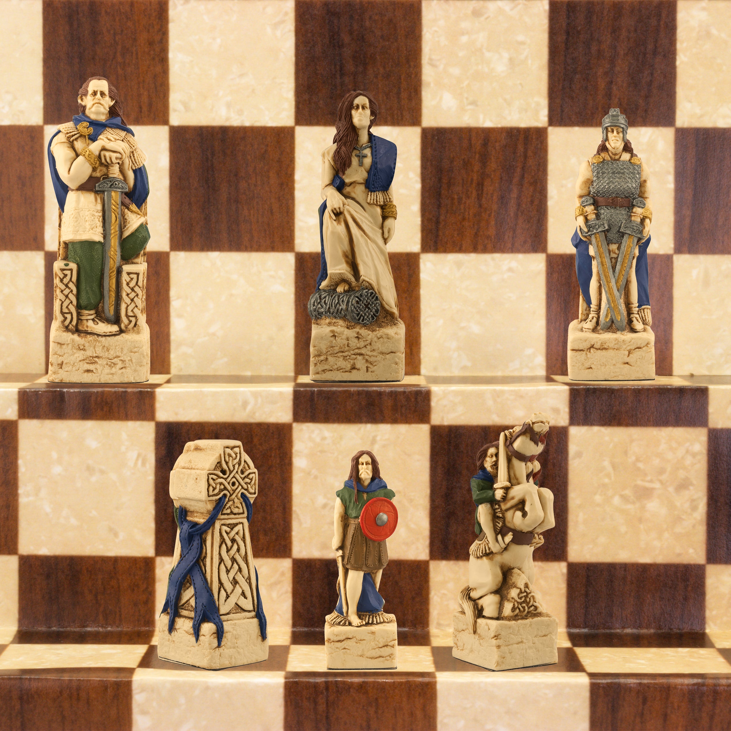 A close-up of a handmade chess set with pieces designed in Celtic styles, set up on a wooden chess board.