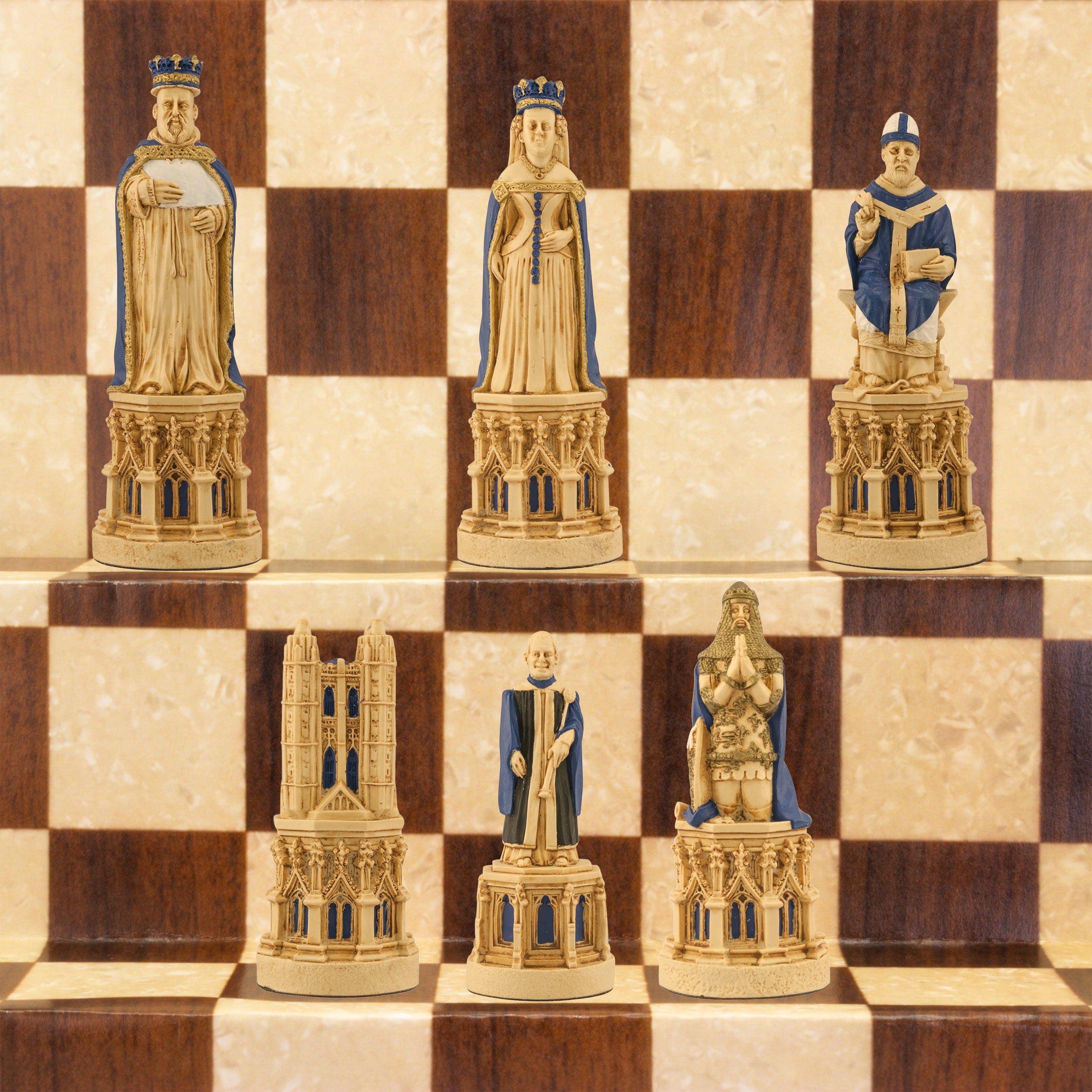 The blue coloured side of a hand painted chess set inspired by the architecture and statuary in and around Medieval Cathedrals, a chess set of gracious proportions and great detail.
