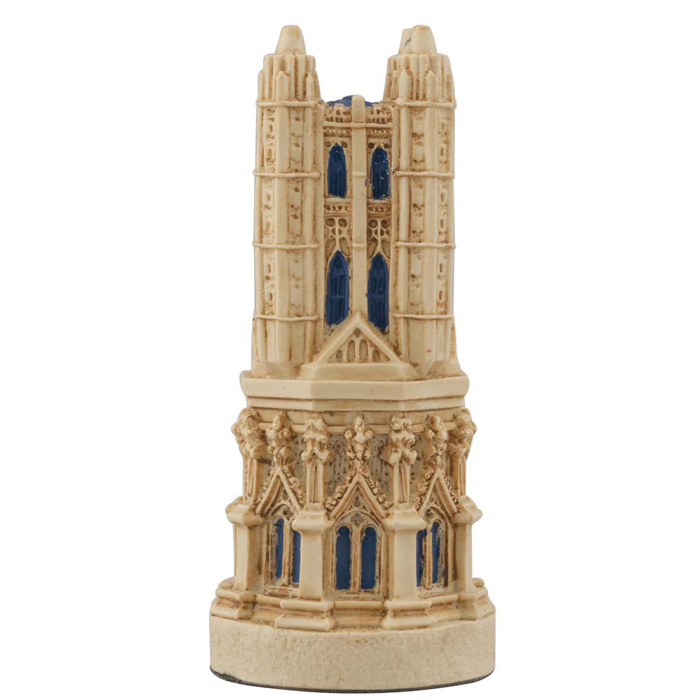 A hand painted cream base, blue accented chess piece depicting a magnificent bell tower, typically found in most cathedrals.