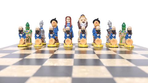 A set of hand-painted chess pieces based on characters on the side of good in the Wonderful Wizard of Oz, displayed on a chessboard.