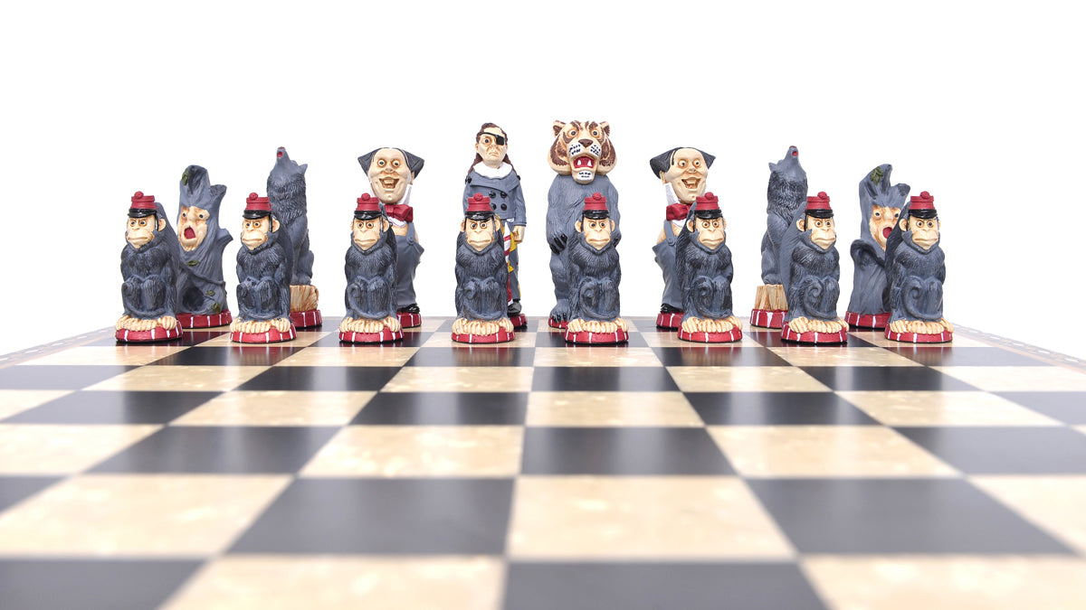 A set of hand-painted chess pieces based on characters on the side of evil in the Wonderful Wizard of Oz, displayed on a chessboard.
