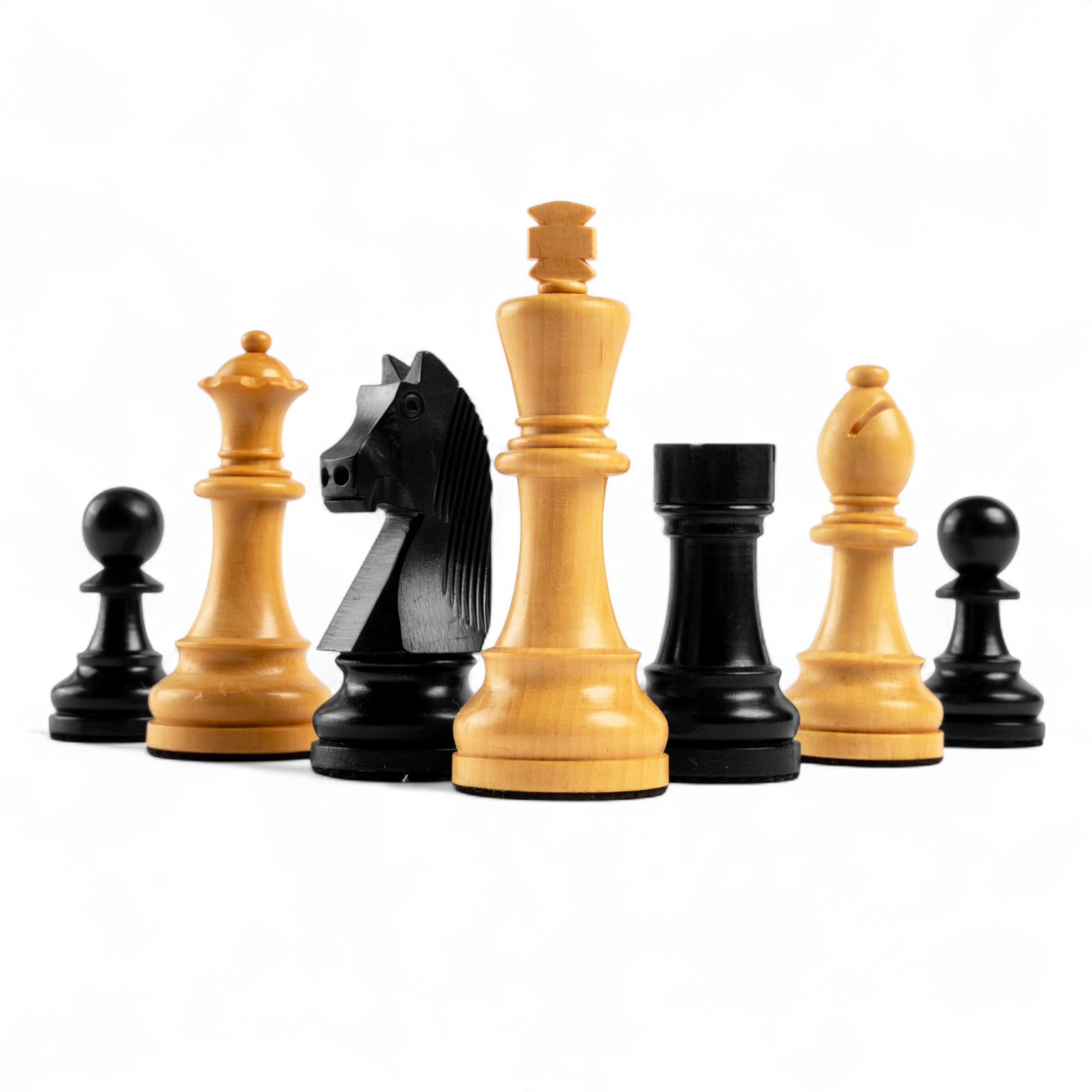 Set of black and beige chess pieces on a white background