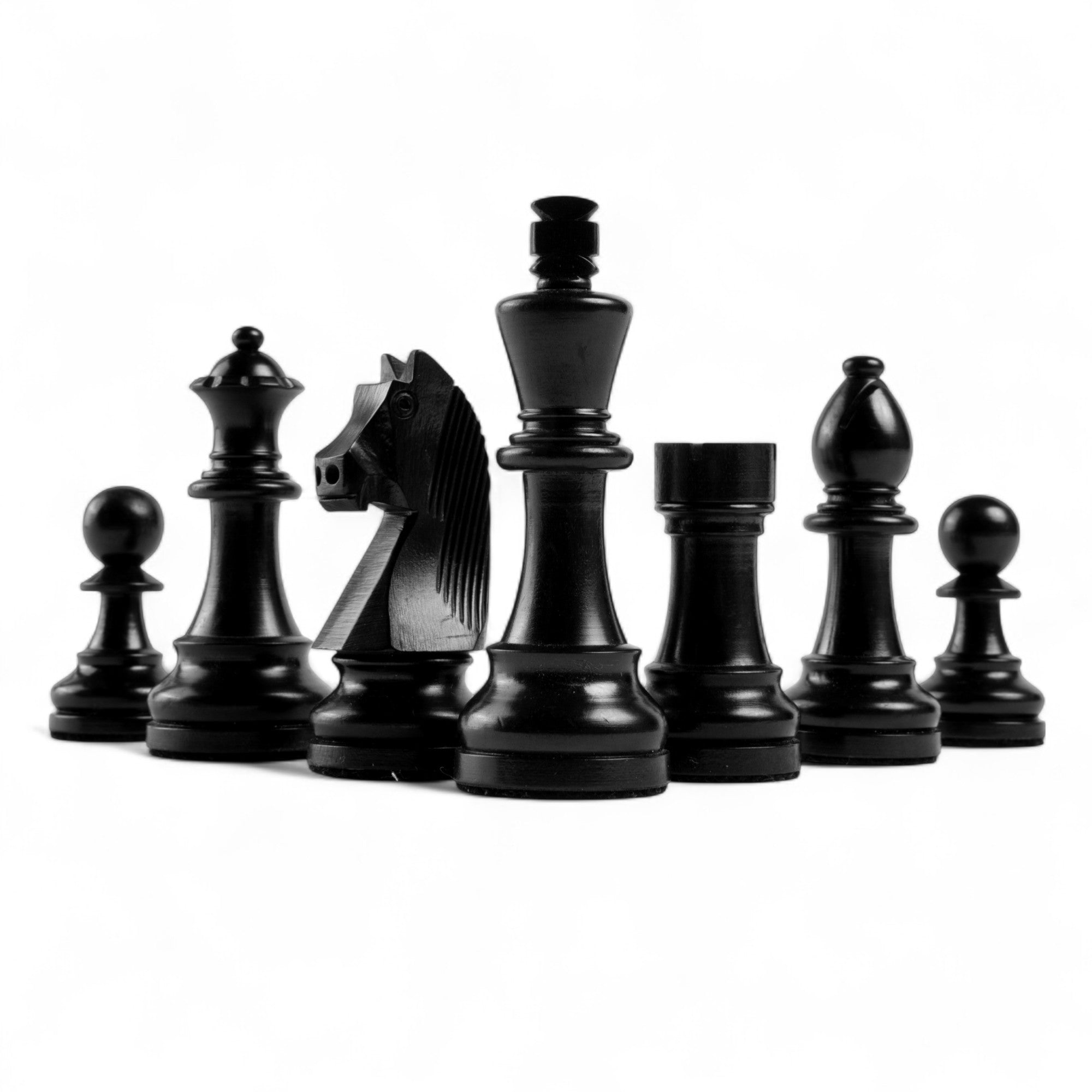 Set of black chess pieces on a white background