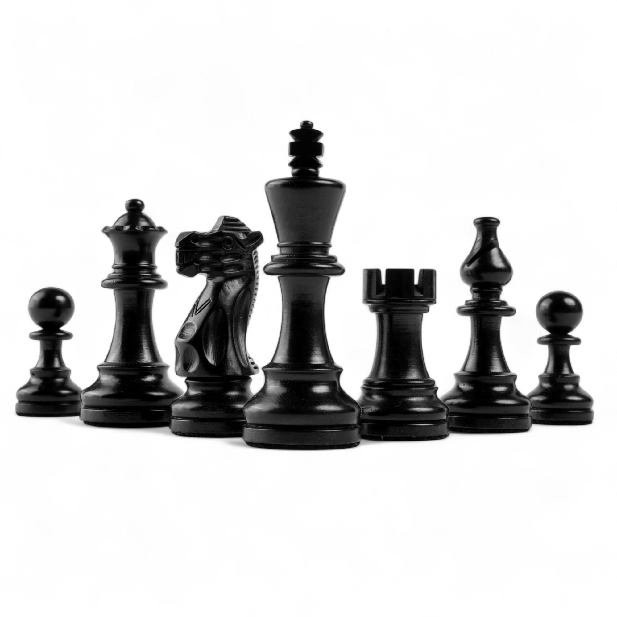 Set of black chess pieces on a white background