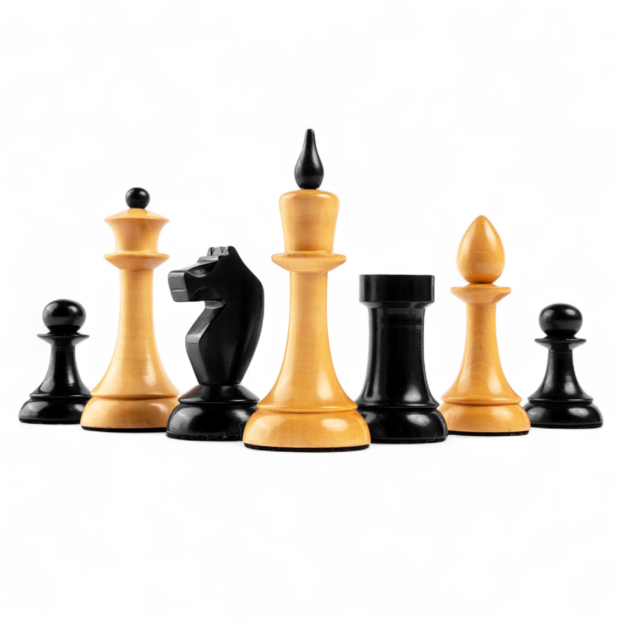 Set of black and beige chess pieces on a white background