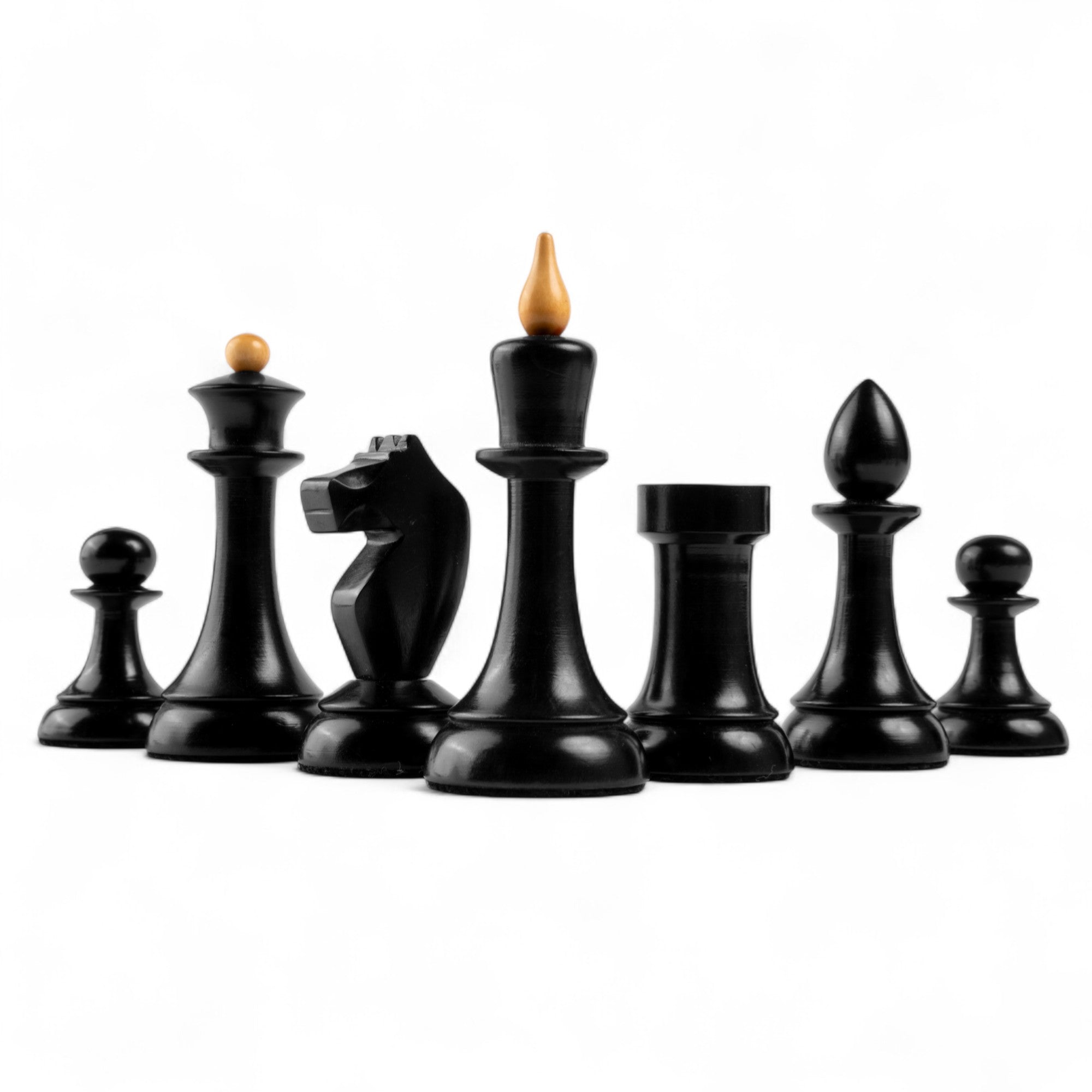 Set of black chess pieces on a white background