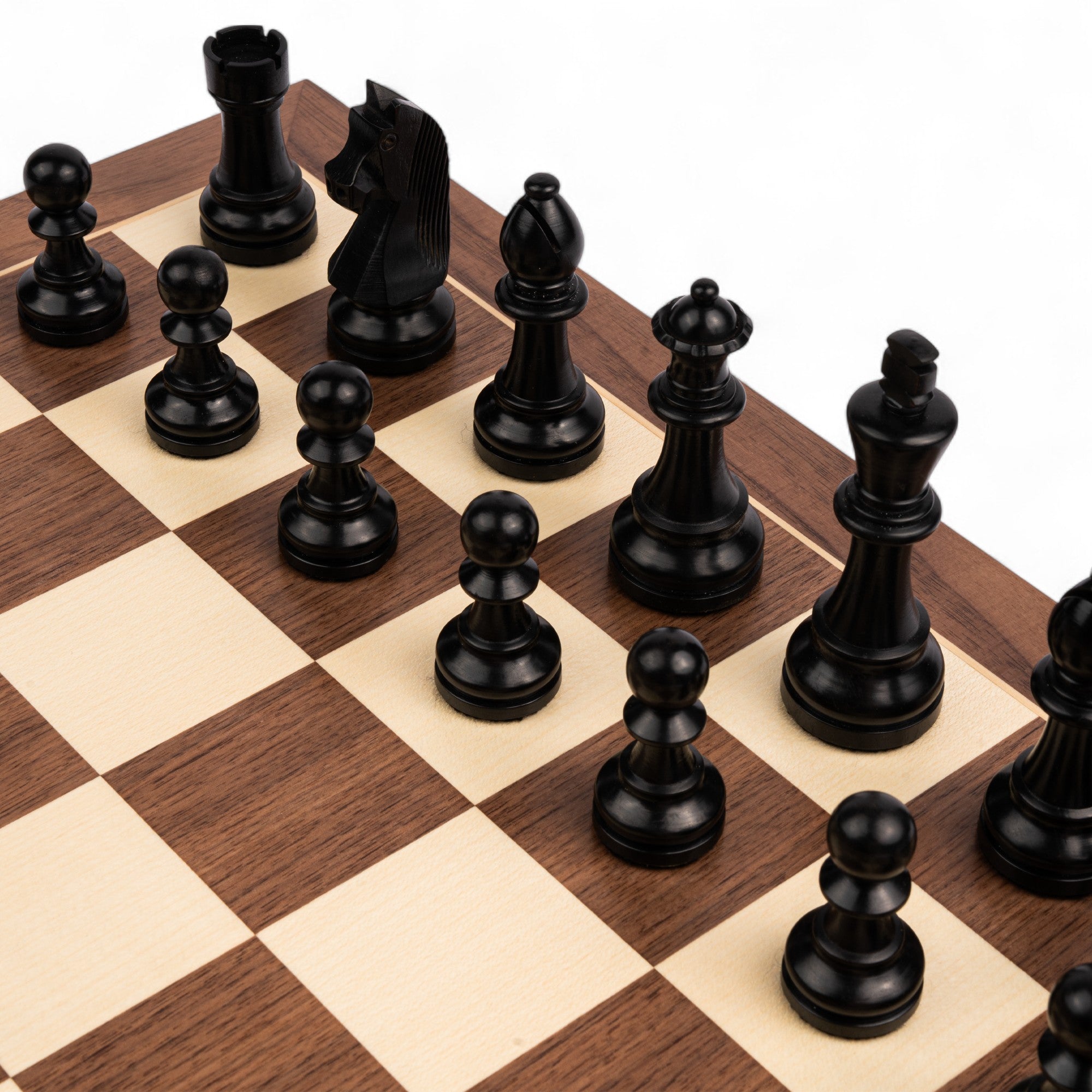 Black chess pieces on a wooden chessboard