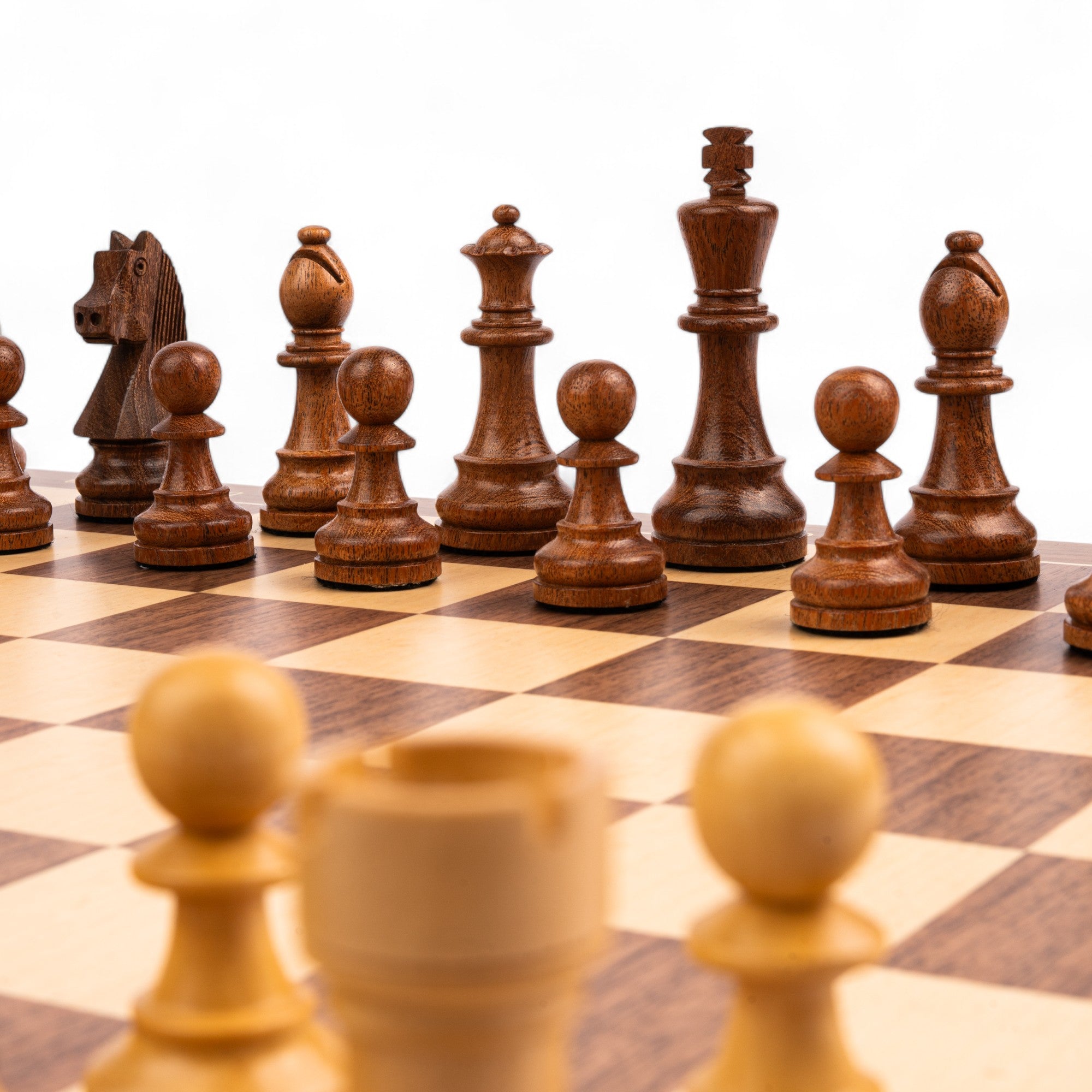 Wooden chess pieces on a checkered chessboard