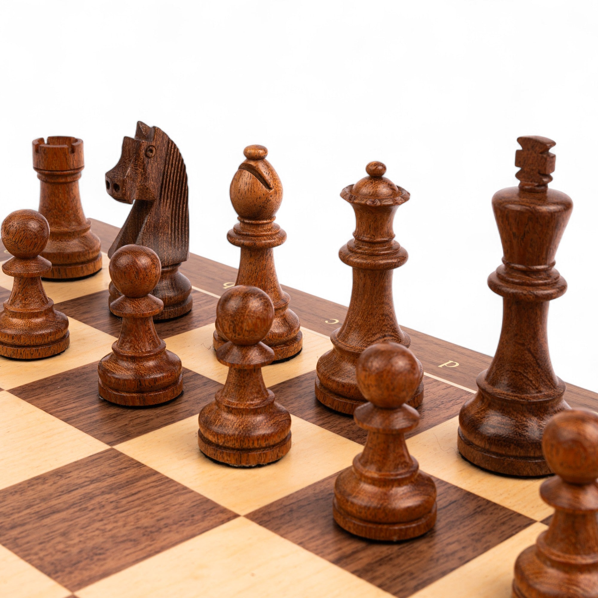Wooden chess pieces on a chessboard with a white background
