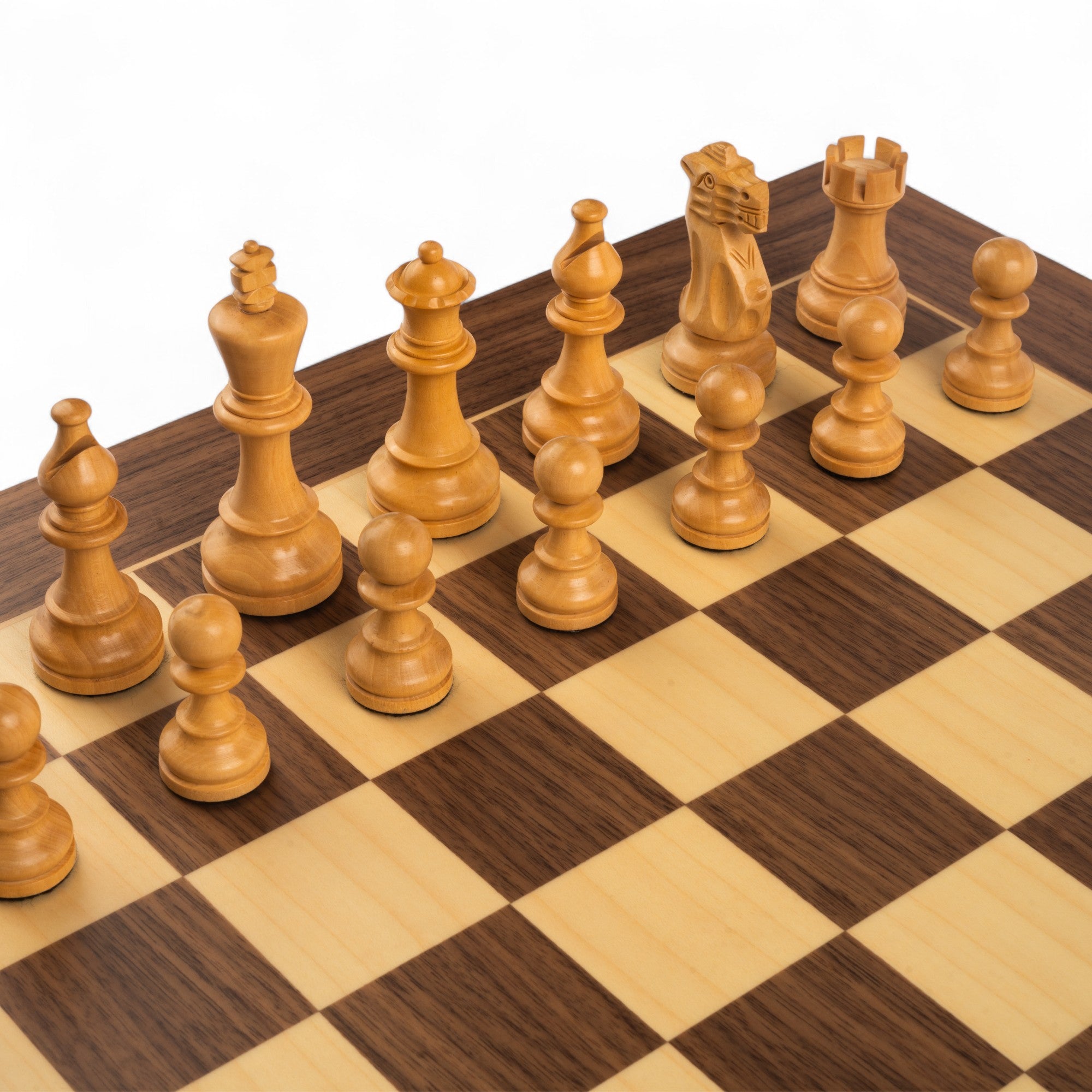 Wooden chess pieces on a checkered wooden chessboard